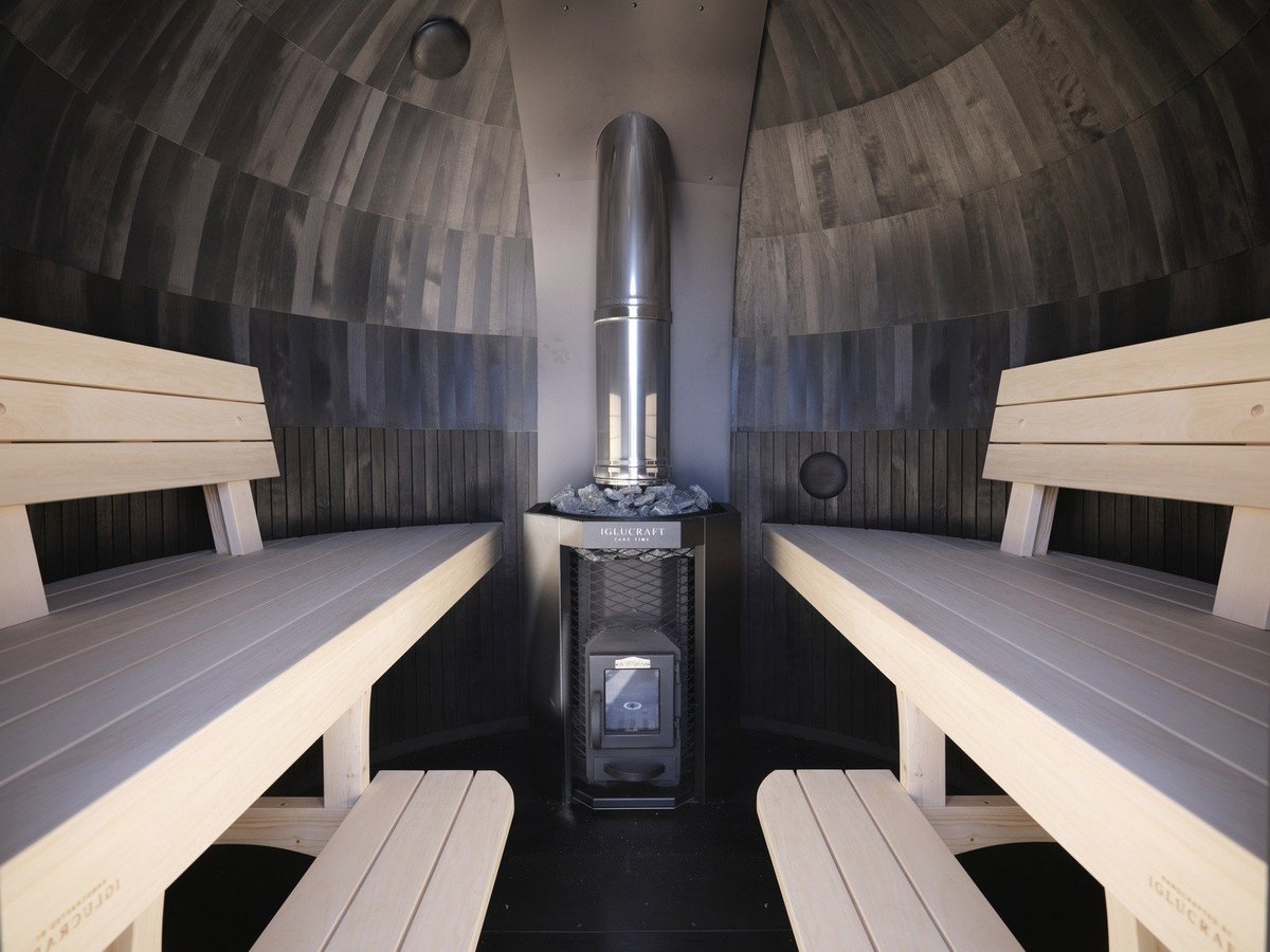 Inside an IgluCraft Single Iglusauna with benches and stove