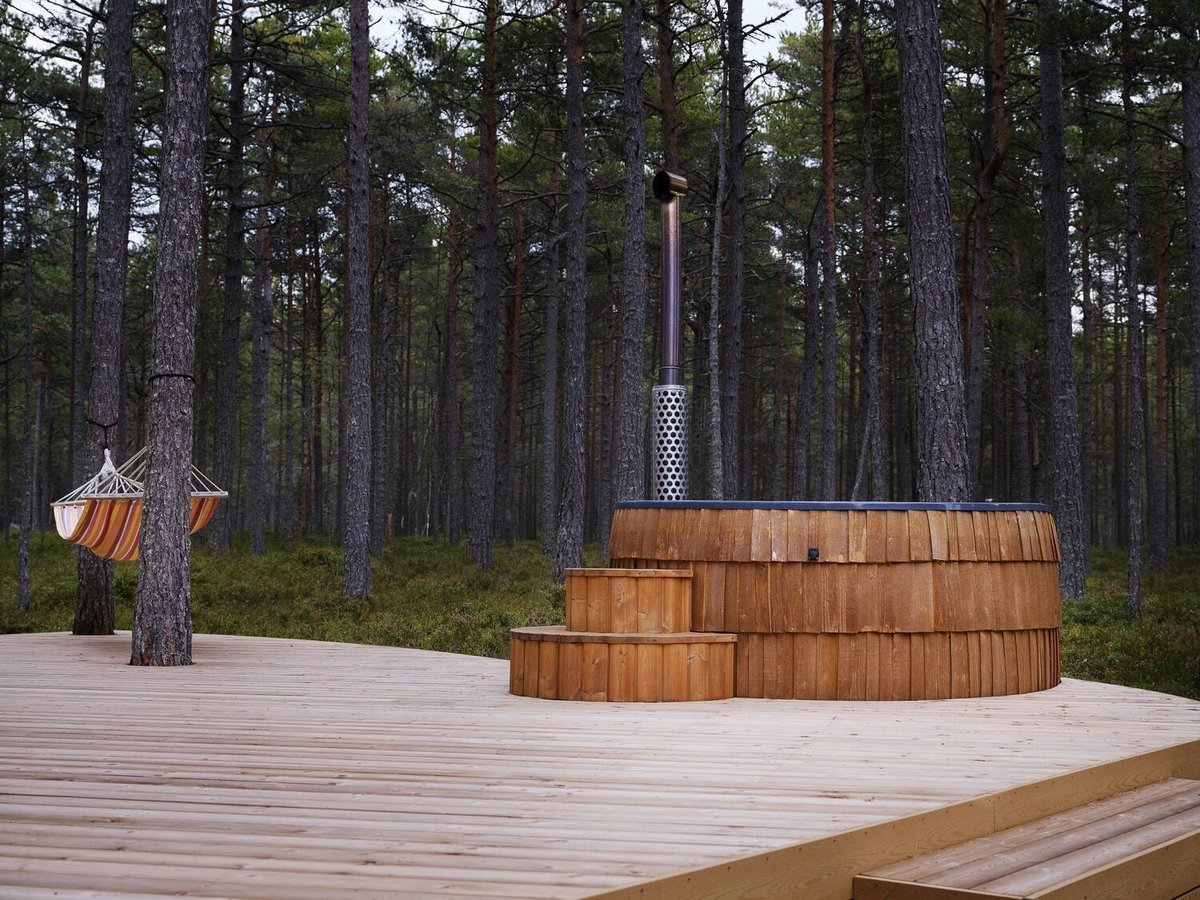 IgluCraft wood-burning hot tub with steps on a wooden deck