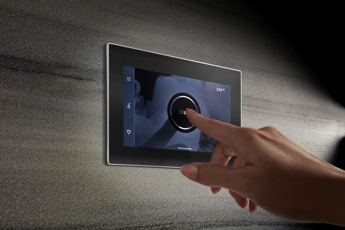 Hand using the Mr.Steam iSteamX touch-screen steam shower control